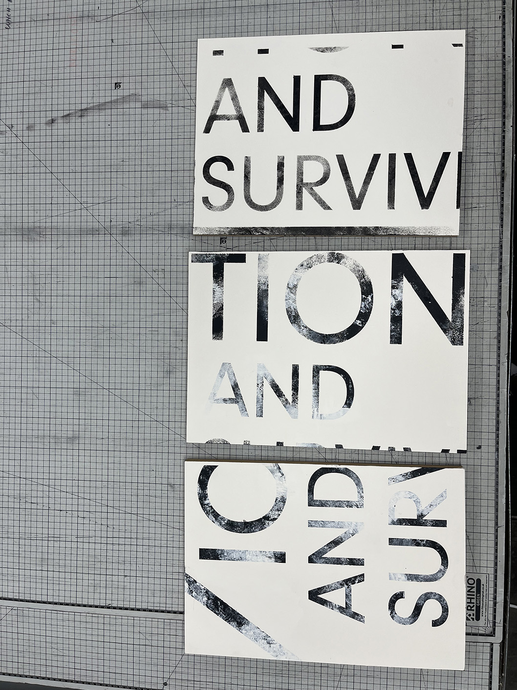 Test samples of painted effect for exhibition identity created using numerous techniques and stencils as guide