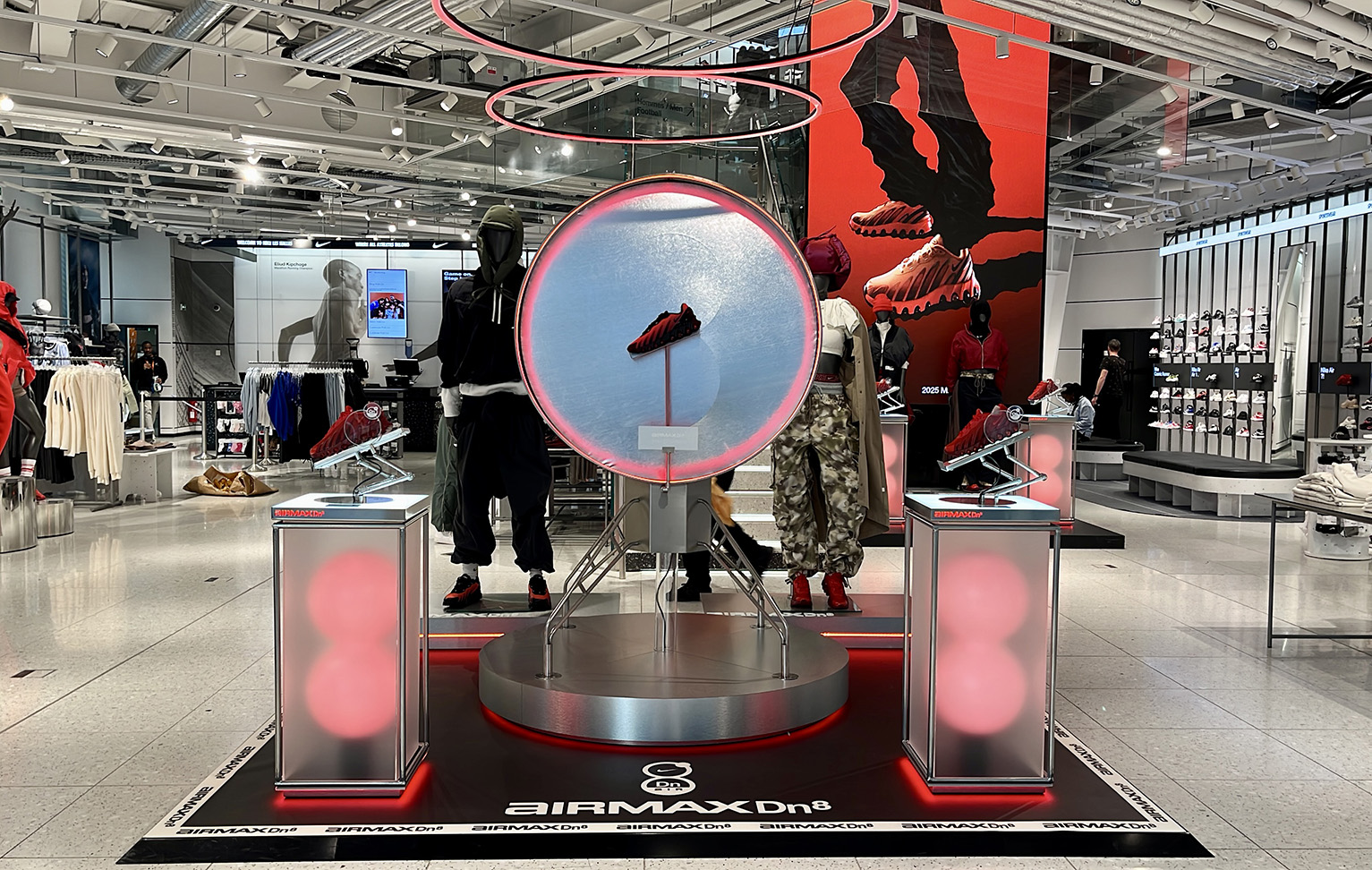 Custom fabricated display elements and brand integration for Nike Airmax Dn8 at Nike Les Halles Paris including moving shoe display, lit podiums and plinths
